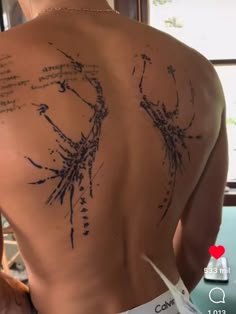 the back of a woman's body with writing all over her upper and lower back