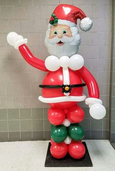 a large balloon santa clause standing on top of a table