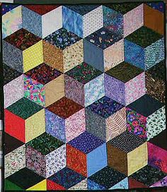 a multicolored patchwork quilt on display