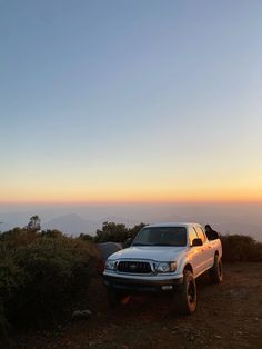 a white truck parked on top of a hill