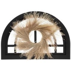 an animal fur wreath on top of a black shelf