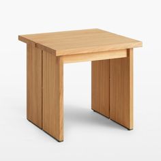 a small wooden table sitting on top of a white floor