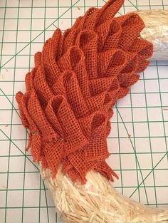 an orange piece of cloth sitting on top of a cutting board