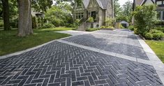 a brick driveway in front of a house