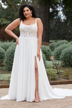 a woman in a white dress posing for the camera