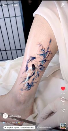 a person with a tattoo on their leg that is covered in blue ink and water