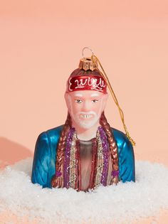 a glass ornament in the shape of a man's head on top of snow