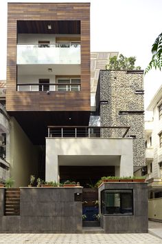 an apartment building with two balconies on the second floor