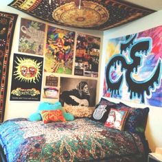 a bed sitting under a ceiling covered in pictures