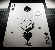 a playing card with the silhouette of a golf ball on it