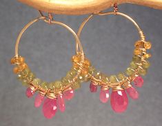 Cleopatra 113 Hoops wrapped with orange by CalicoJunoJewelry, $148.00 Gold Peridot Jewelry With Gemstone Accents, Peridot Jewelry With Gemstone Accents In Gold, Fusion Style Pink Jewelry With Gemstone Accents, Pink Fusion Style Gemstone Jewelry, Unique Pink Jewelry With Gemstone Accents, Pink Tourmaline Jewelry With Gemstone Accents, Pink Gold Tourmaline Jewelry With Gemstones, Pink Round Tourmaline Jewelry, Pink Fusion Jewelry With Natural Stones