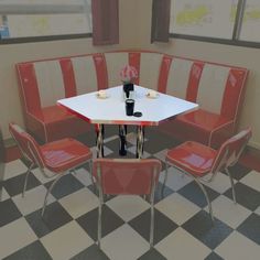 a table and four chairs in a room with black and white checkered flooring