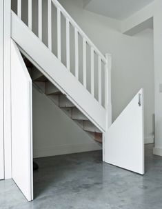 an open door leading to a white staircase