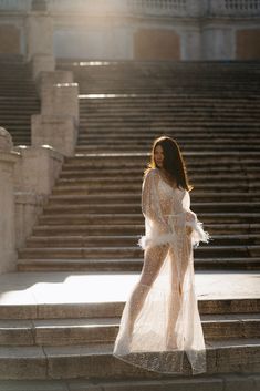 a woman is standing on some steps