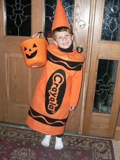 a young boy dressed up as a candy cornucopie holding an orange bag