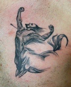 a man with a horse tattoo on his chest is holding onto the tail of another horse