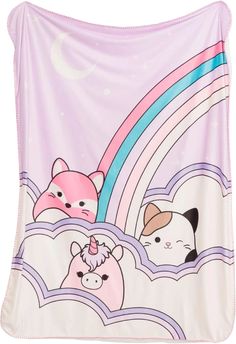 a blanket with cartoon animals on it and a rainbow in the sky behind them,