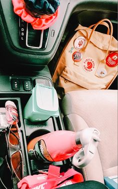 the interior of a car with various items in it, including shoes and handbags