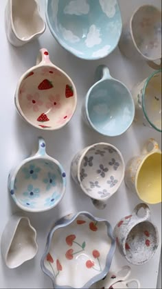 many bowls and spoons are laid out on the table