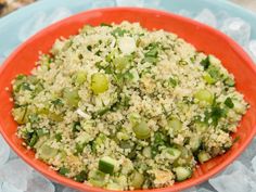 a red bowl filled with rice and vegetables