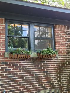 two planters on the side of a brick building