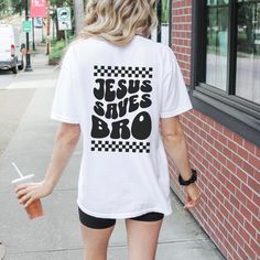 "\"Embrace your faith and spread the message of hope with our 'Jesus Saves Bro' T-shirt! This shirt isn't just about making a statement - it's about sharing the transformative power of God's love in a fun and relatable way. Whether you're at church, out with friends, or simply running errands, our 'Jesus Saves Bro' T-shirt is a powerful reminder of the saving grace and eternal love of Jesus Christ. It's more than just clothing - it's a declaration of your faith and a beacon of hope in a world th Inspirational Graphic Print Top For Streetwear, Inspirational White Shirt With Graphic Print, Inspirational White Graphic Print T-shirt, Church Merch, Jesus Saves Bro, Saving Grace, Aesthetic Shirt, Beacon Of Hope, Jesus Christus