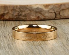 a gold wedding band with the word love on it