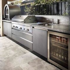 an outdoor kitchen with stainless steel appliances