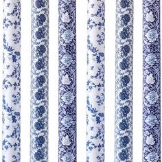 four blue and white candles are lined up against a white background with floral designs on them