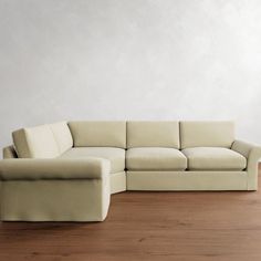 a white couch sitting on top of a wooden floor