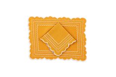 an orange napkin with white scalloped edges and a yellow border on the front