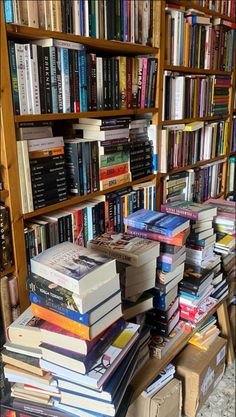 a bookshelf filled with lots of books on top of each other