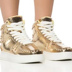 Gold Embellished High Top Sneakers. Metallic Faux Leather Upper. Lace Up Vamp, White Laces. Cushioned Insole And Textured Rubber Outsole. Perforated Rounded Toe Silhouette. Rhinestone Studded Embellishments. Faux Gold Metallic Hardware. 4.5” Shaft Height. 1.5” Sole Height. Beautiful In Person. And Comfortable. Final Sale Trendy Gold Sneakers For Party, Trendy Gold Party Sneakers, Gold Sneakers With Rhinestones And Round Toe, Gold Rhinestone Sneakers With Round Toe, Gold Platform Sneakers With Round Toe, Gold Embellished Sneakers With Round Toe, Embellished High-top Party Sneakers, Embellished Gold Sneakers With Round Toe, Gold Embellished Round Toe Sneakers