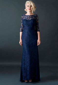 a woman in a long blue lace dress