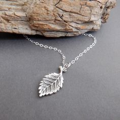 sterling silver curved leaf necklace, 7/8" long - A small solid sterling silver charm, measuring 7/8" long (21 mm) down, 3/8" (10 mm) across. - Necklace is 1.5 mm cable chain, with lobster clasp and locking jump rings, all solid sterling silver.  - Realistic design is blackened (oxidized) to bring out the details. Looks the same on front and back. - Packaged in a modern circular tin, ready for gift giving, and comes with a silver polish pad and care instructions. Customize chain length or "charm Minimalist Leaf-shaped Sterling Silver Jewelry, Minimalist Sterling Silver Leaf Jewelry, Everyday Sterling Silver Leaf Jewelry, Nickel-free Leaf-shaped Sterling Silver Jewelry, Nature-inspired Silver Jewelry With Charms, Nature-inspired Sterling Silver Pendant Charm Necklace, Dainty Sterling Silver Leaf Jewelry, Hypoallergenic Silver Leaf Jewelry, Petite Jewelry