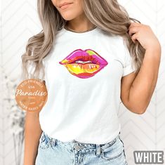 Woman Lips Gift T-shirt, Colorful Kiss Shirt, Premium Soft T-Shirt, Printed in the USA Direct on Garment Printing using Water Based Eco-friendly Inks. Unisex T-shirt Sizing, Relaxed Fit For Women.  Go 1-2 sizes up for the modern oversized look. You can compare one of your tees to the sizing chart available in our listing photos. Colors might be look a bit different on different screens. Our shirts are high quality, soft and breathable   Dark Designs won't have enough contrast on dark color shirts and vice versa, so please choose the right color shirt :) We DO NOT customize multicolored designs, but we accept custom orders. - 100% ring-spun cotton - Heather Colors are a cotton/polyester blend Soft cotton and quality print make users fall in love with these tees. They have-ribbed knit collar Trendy Multicolor Top With Sublimation Print, Multicolor Graphic Tee With Custom Print, Multicolor Custom Print Graphic Tee Shirt, Multicolor Custom Print Graphic Tee, Colorful Graphic Print T-shirt, Colorful Letter Print Top For Summer, Trendy Short Sleeve Shirt With Multicolor Print, Trendy Multicolor Print Short Sleeve Shirt, Colorful Trendy Short Sleeve Shirt