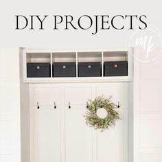 an entry way with white cabinets and black baskets on the wall next to it is a wreath that reads, diy projects