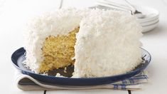 a cake with white frosting is on a plate