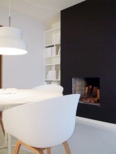 a white dining room table and chairs with a fire place in the fireplace behind it