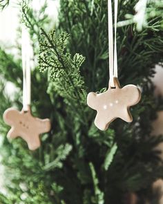 two wooden ornaments hanging from a christmas tree