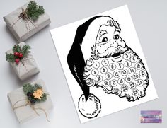 a black and white drawing of santa claus with presents around it on a table next to wrapping paper