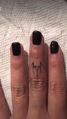 a woman's hand with a small tattoo on it