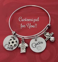 Hand Stamped Soccer Bangle Bracelet Bracelet features 2 custom-stamped discs - one featuring name of your choice and the other featuring player's number, an enamel soccer charm, a soccer jersey charm and a I Love Soccer charm. Fashioned on an adjustable stainless steel bangle. I have 50mm (Children's Size) and 60 (Adult Size) Comes in either an organza pouch or a giftbox depending upon which option you select. ♦ ♦ ♦ ♦ ♦ ♦ ♦ ♦ ♦ ♦ ♦ ♦ ♦ ♦ ♦ ♦ ♦ ♦ Only one side can be stamped as it shows through o I Love Soccer, Soccer Jewelry, Organza Pouch, Anniversary Dates, Personalised Gifts For Him, Stainless Steel Bangles, Jewelry Personalized, Sun And Stars, Buffalo Ny