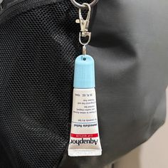 a black bag with a blue tag hanging from it's side