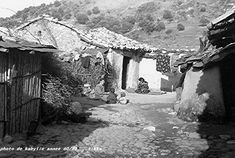 an old black and white photo of a village