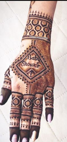 a henna that is on someone's hand with the words baby shower written on it