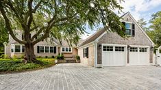 a large brick driveway with two garages on each side