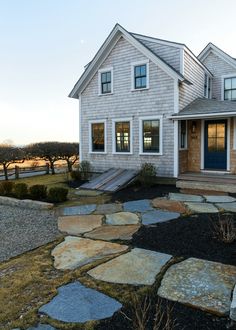 a house with flagstone walkway leading to the front door