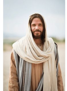 a man with long hair wearing a white scarf