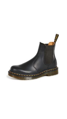 PRICES MAY VARY. Classic Dr. Martens Smooth leather, a lightly textured, highly durable leather with a soft sheen Easy-on, easy-off elastic ankle gusset Signature Doc's DNA, including iconic yellow stitch, air-cushioned soles and scripted heel-loops Heat welted construction A classic Chelsea boot, done Dr. Martens style with the brand's instantly recognizable contrast stitching. Wear this versatile black pair with anything from cropped trousers to off-duty denim. Dr Martens Chelsea, 2976 Chelsea Boots, Dr Martens 2976, Doc Martens Style, Martens Style, Boots Chelsea, Botas Chelsea, Yellow Heels, Black Chelsea Boots